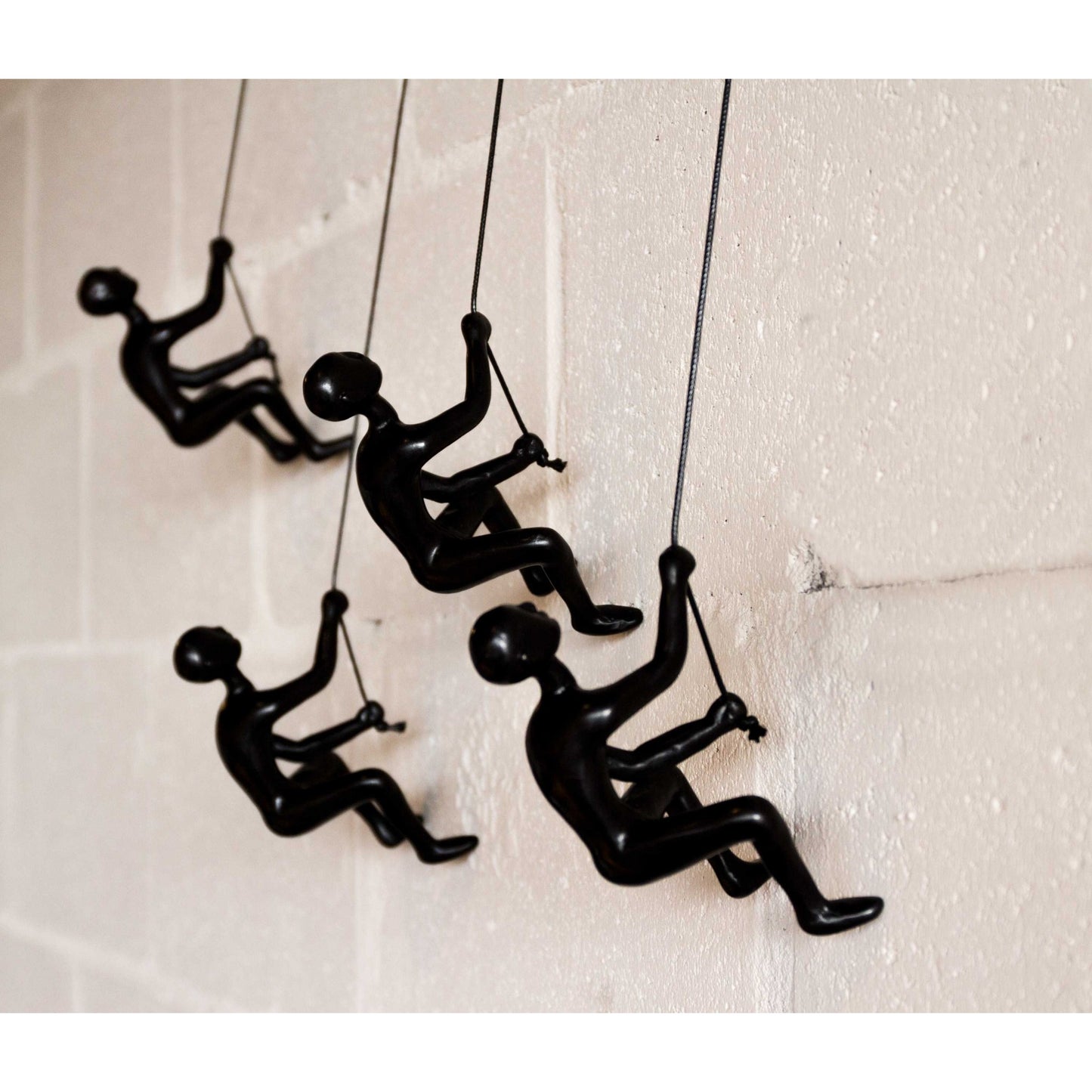 Set of Four Black Resin Climbing Man Wall Sculptures